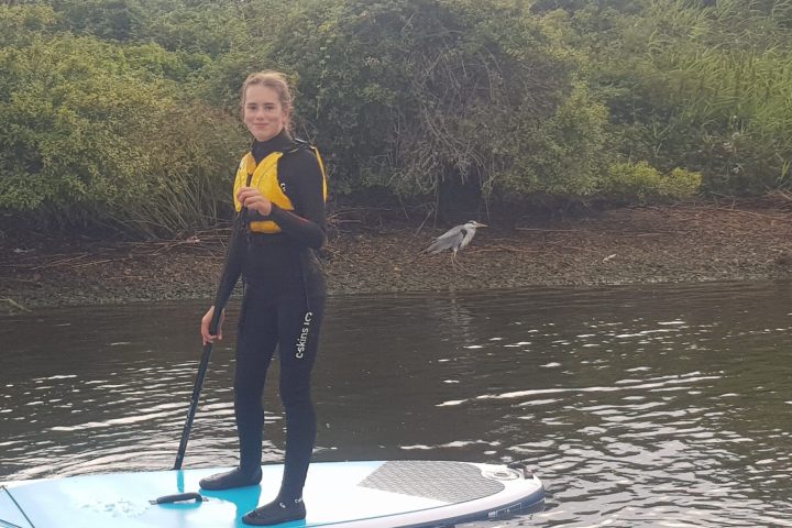 a person standing next to a body of water