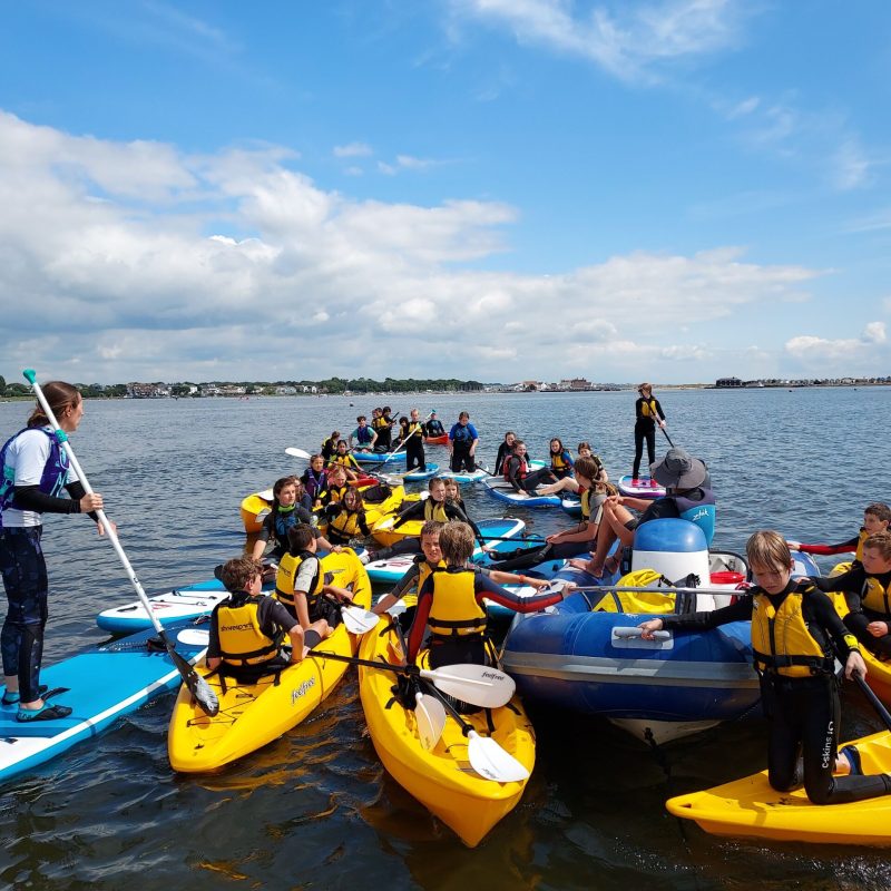 a group of people on a raft in a body of water