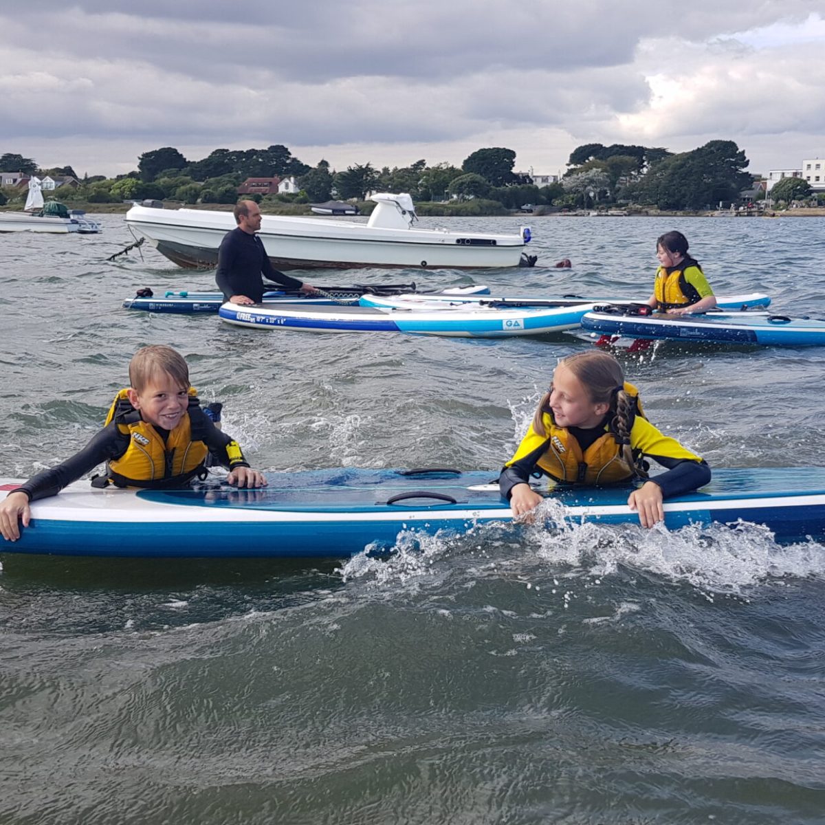 a group of people riding on the back of a boat in the water