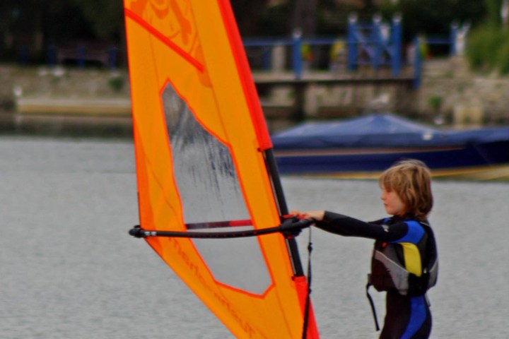 a man carrying a surf board in the water