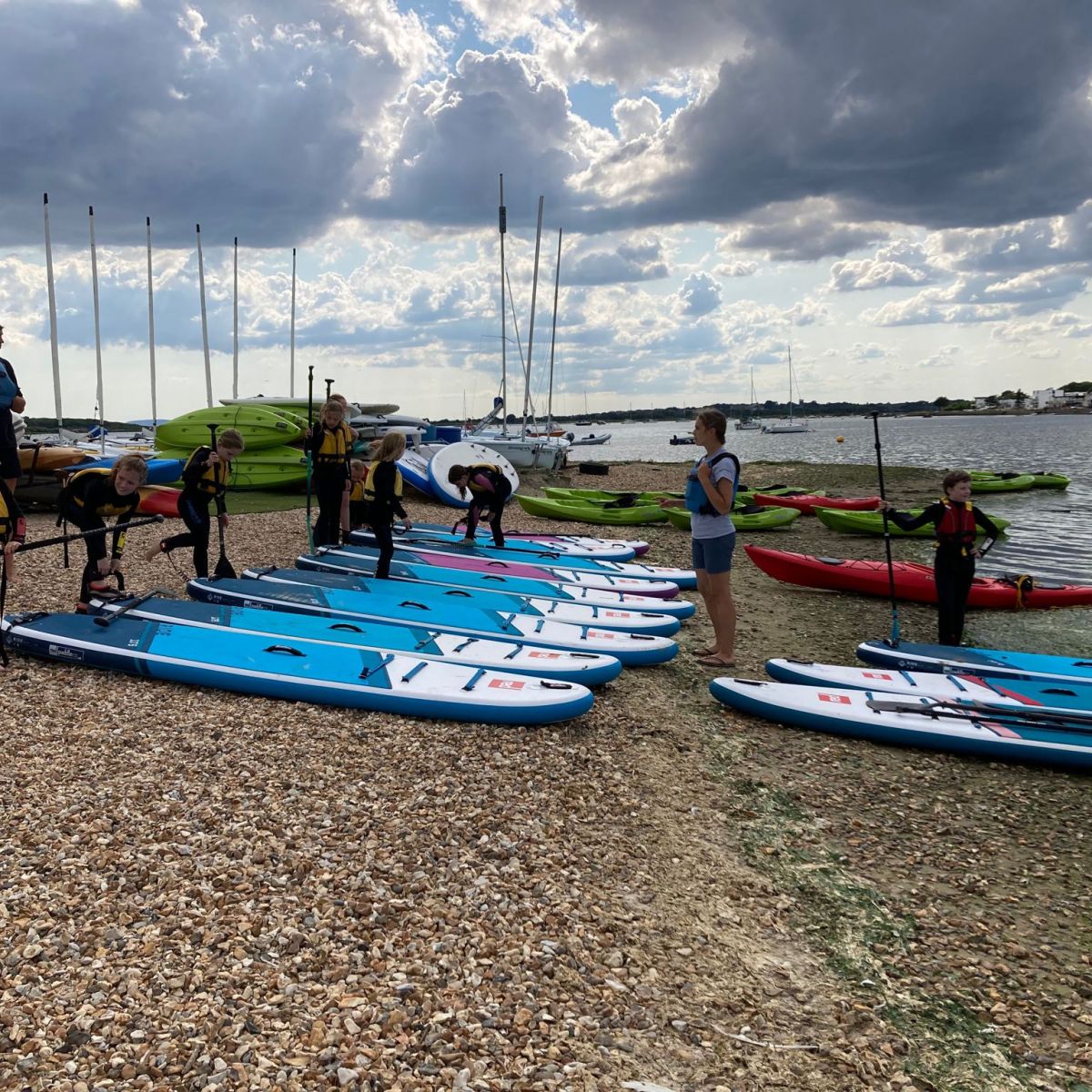 a group of people in a boat on the beach