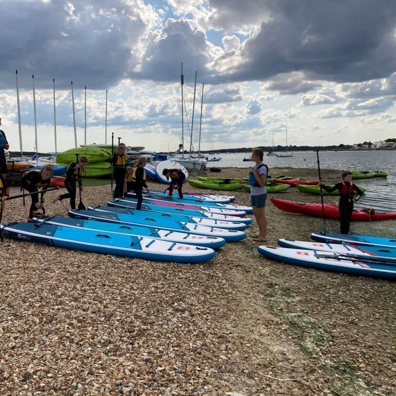 a group of people in a boat on the beach