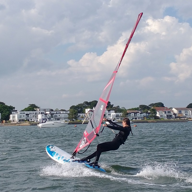 a man flying a kite in a large body of water