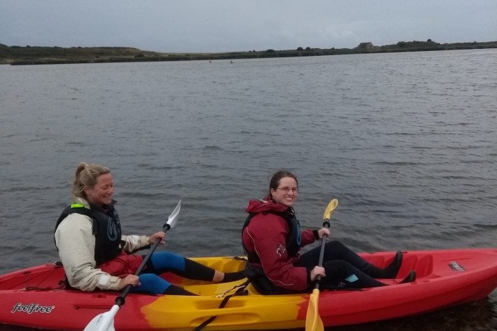 a group of people in a small boat in a body of water