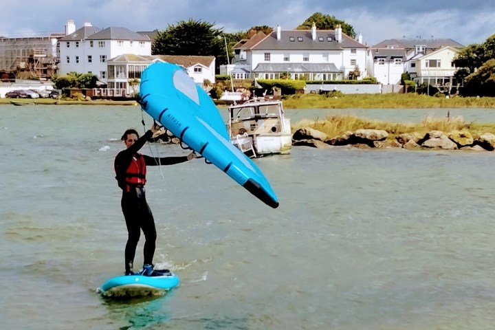 a person is surfing in front of a building