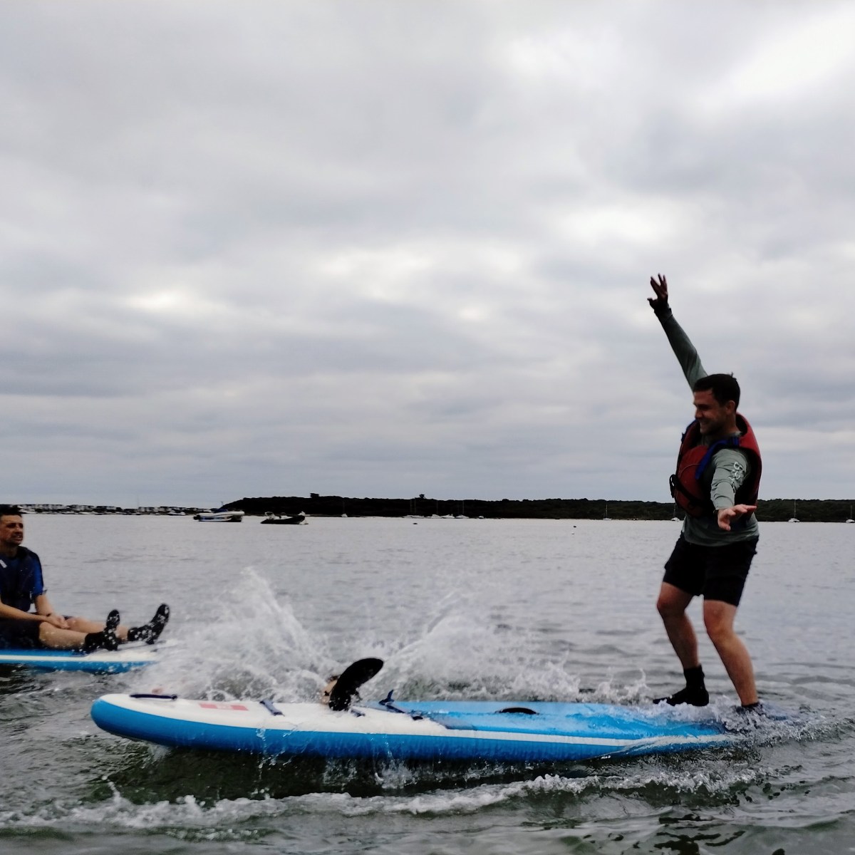 a group of people riding on the back of a boat in the water